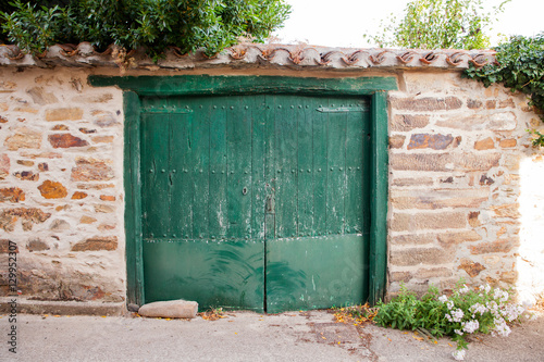 Old green door of a Spanish house
