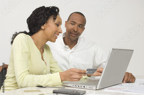 Happy African American couple making an online transaction