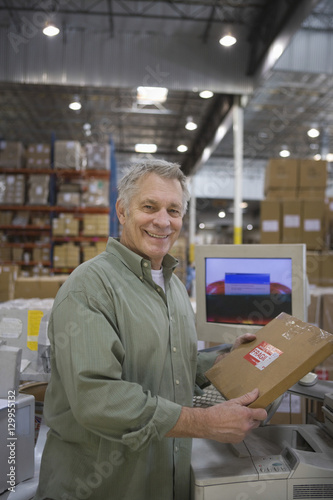 Portrait of a smiling man working in distribution warehouse