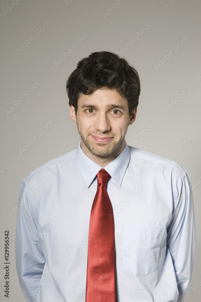 Portrait of a smiling confident businessman isolated over grey background Portrait of a smiling confident businessman isolated over grey background