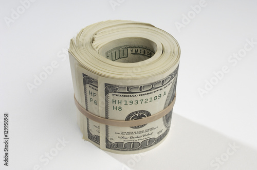 Rolled up US paper currency isolated over white background