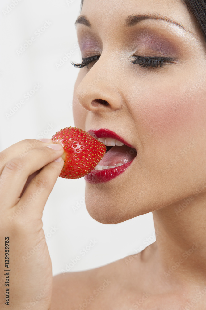 Closeup of an seductive woman eating strawberry Closeup of an seductive woman eating strawberry