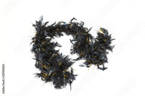Black feather boa with gold tinsel isolated on white background photo