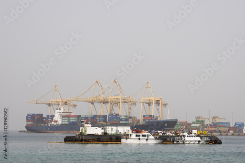 Khor Fakkan UAE Large cargo ships docked to load and unload goods at Khor Fakkport © moodboard