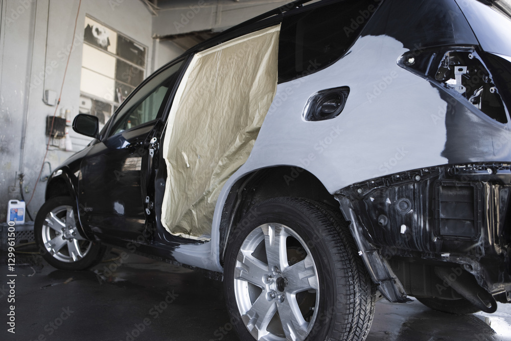 View of a damaged sports utility vehicle in garage
