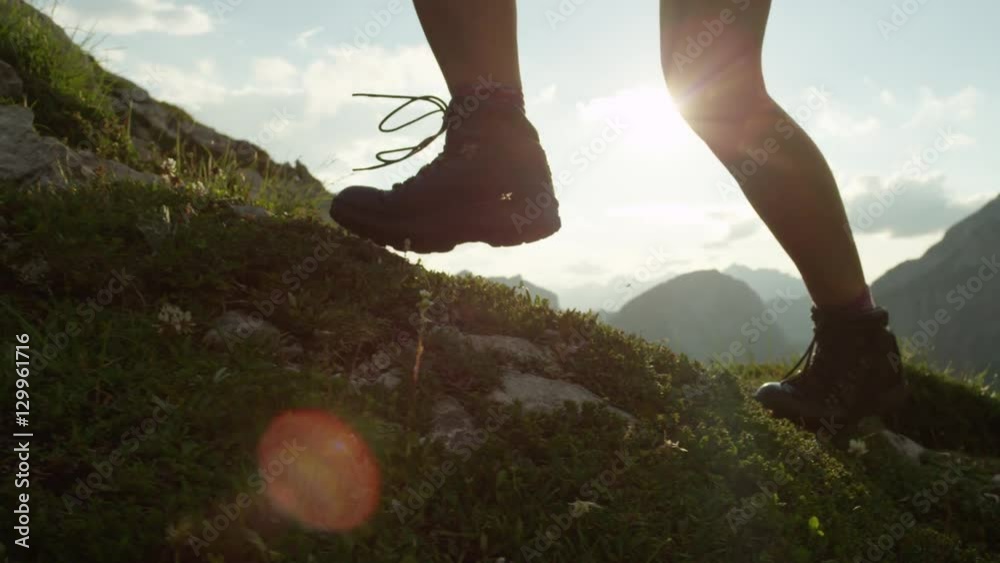 CLOSE UP: Detail of leather mountain shoes and woman climbing steep mountain