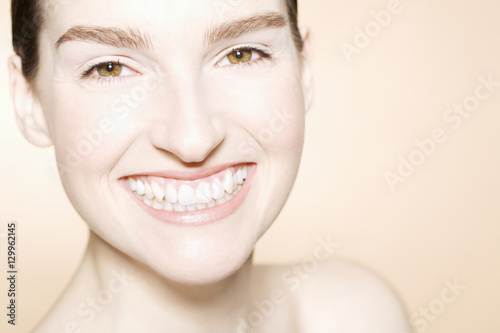 Closeup portrait of a happy beautiful young woman with clean fresh skin