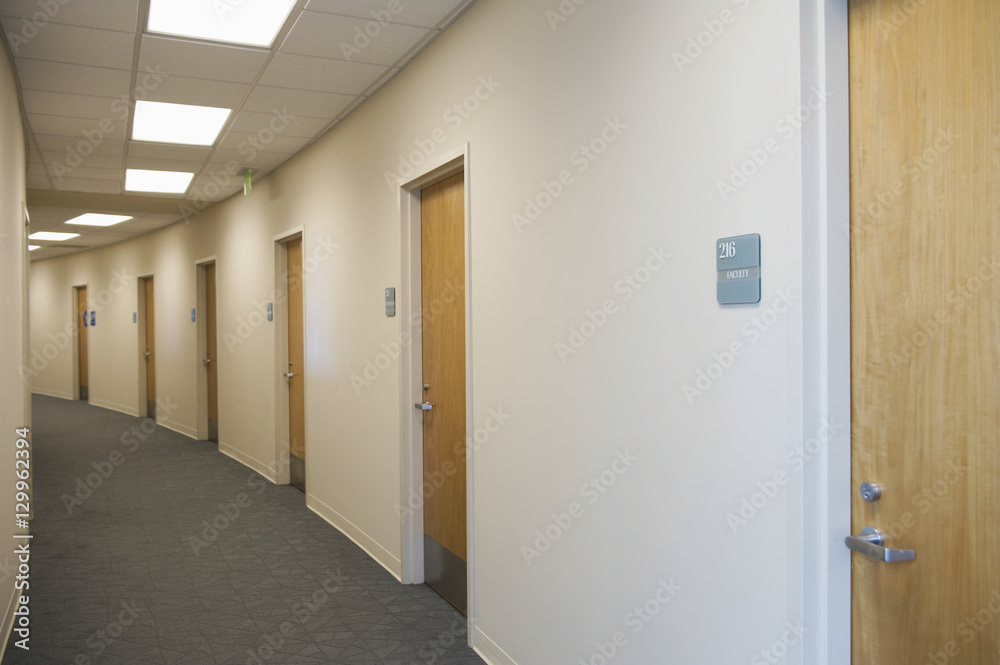 View of an empty corridor with closed doors View of an empty corridor with closed doors
