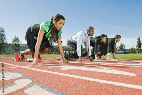 Confident multiethnic business people at starting line