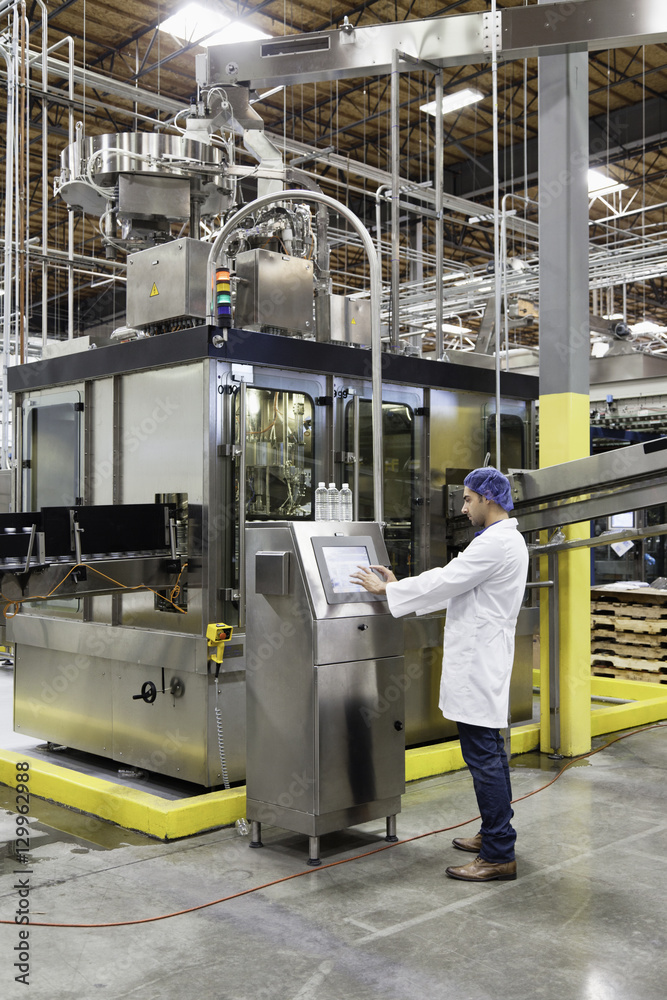 Man working on machinery in bottling industry Man working on machinery in bottling industry