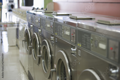 Canvas Print Row of washing machines in launderette