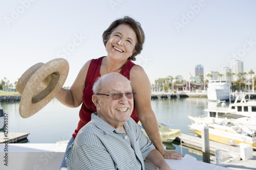 Portrait of playful senior Caucasian couple at harbor