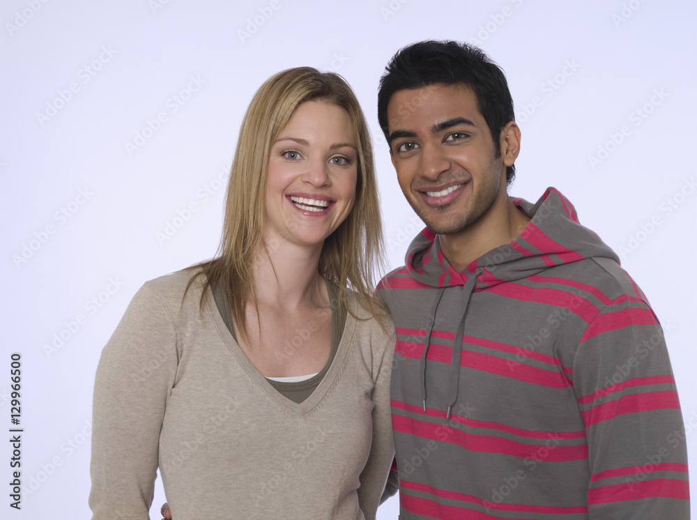 Portrait of a smiling young man and woman against purple background Portrait of a smiling young man and woman against purple background