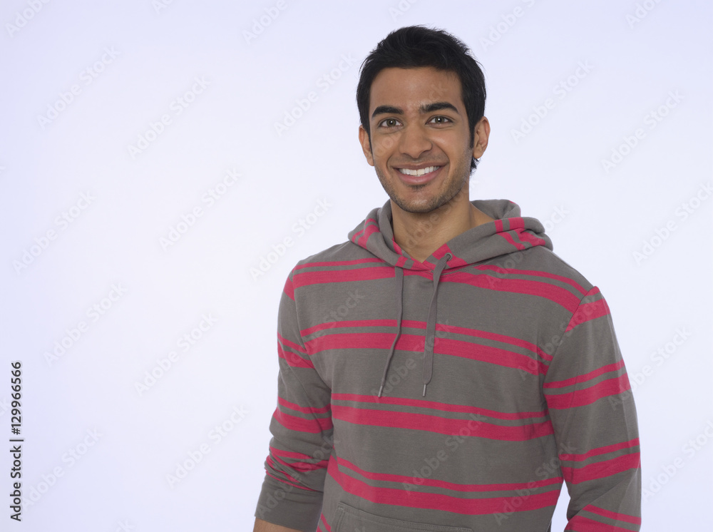 Portrait of a smiling young Indian man against purple background Portrait of a smiling young Indian man against purple background