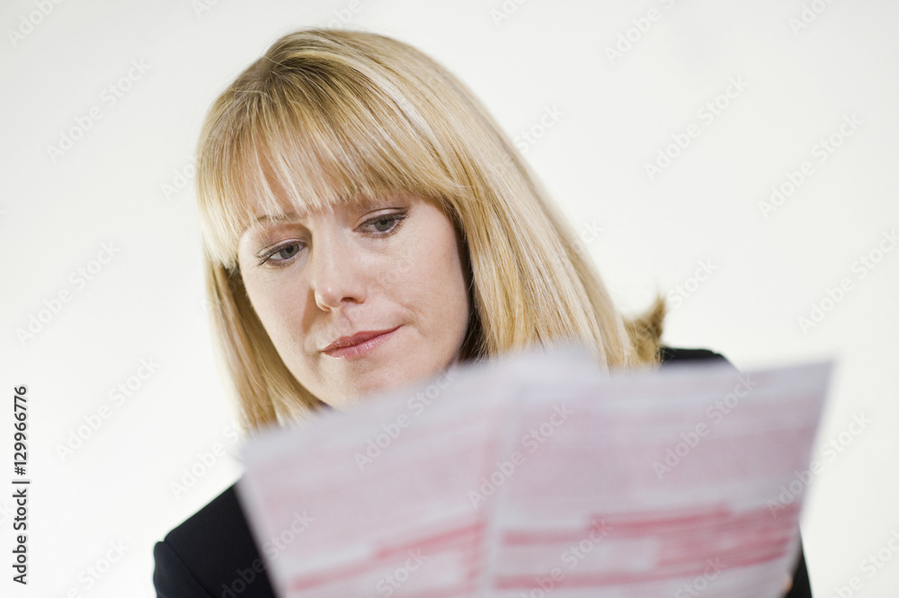 Serious financial advisor studying paperwork Serious financial advisor studying paperwork