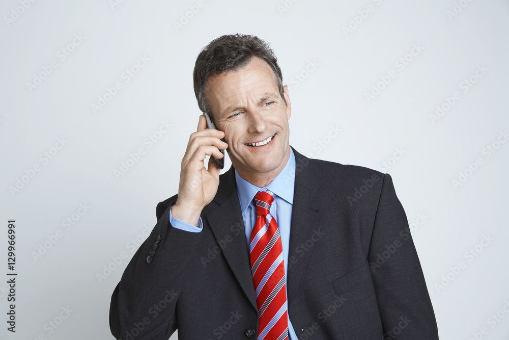 Happy businessman communicating on cell phone isolated over white background Happy businessman communicating on cell phone isolated over white background