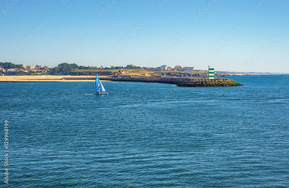 Yacht boat entering a port near ocean pier