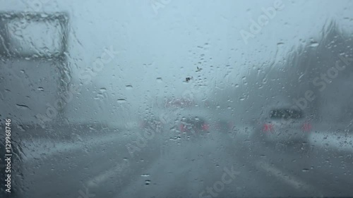 FPV: Dangerous car drive in heavy traffic on highway in bad weather condition