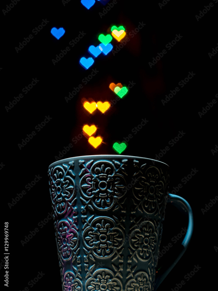 Cup with defocused hearts bokeh. Side view Cup with defocused hearts bokeh. Side view