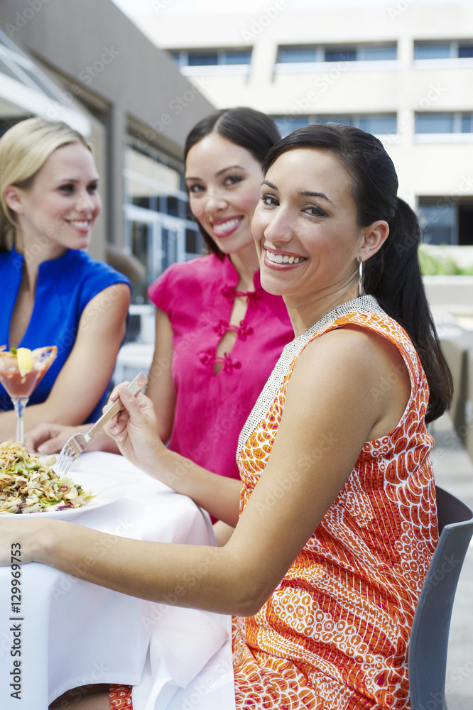 Group of female friends eating out together at a restaurant