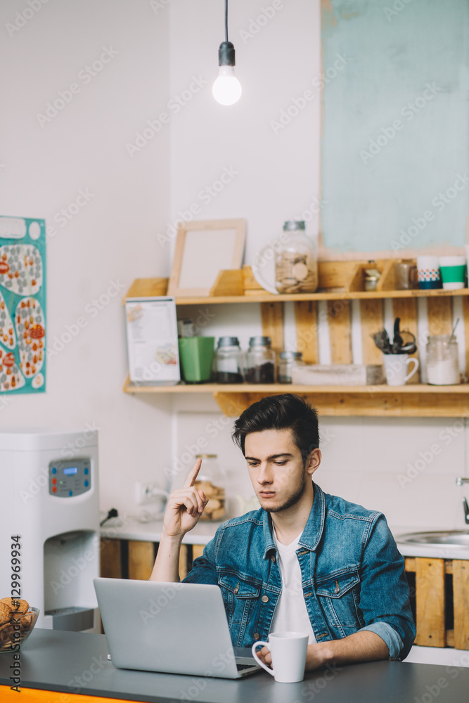 Young man with beard working on laptop Young man with beard working on laptop