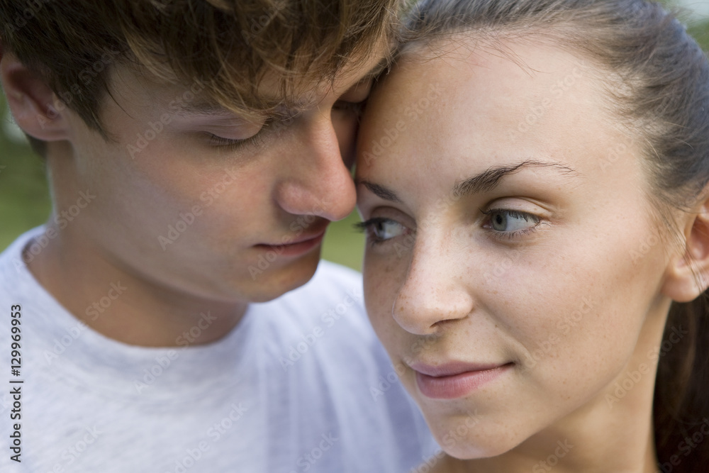 Closeup portrait of a loving young couple outdoors Closeup portrait of a loving young couple outdoors