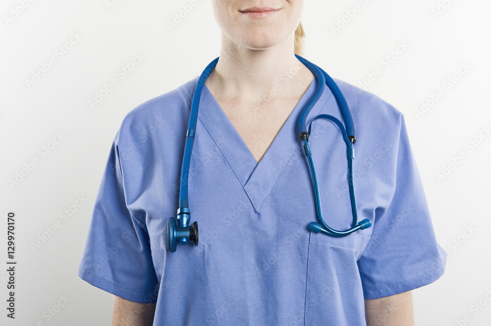 Midsection of a female surgeon with stethoscope wearing around neck isolated over white background Midsection of a female surgeon with stethoscope wearing around neck isolated over white background
