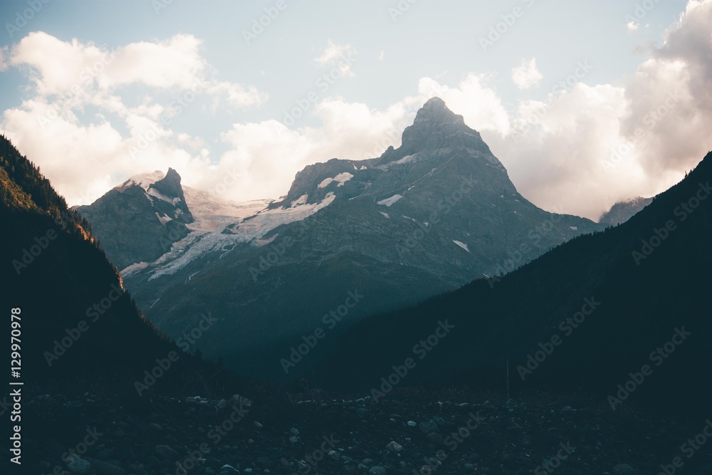 Obraz premium Mountain summer landscape with forest and high peaks.