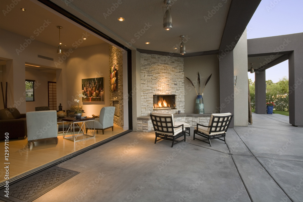 View of chairs by fireplace in patio of a modern home - obrazy, fototapety, plakaty 