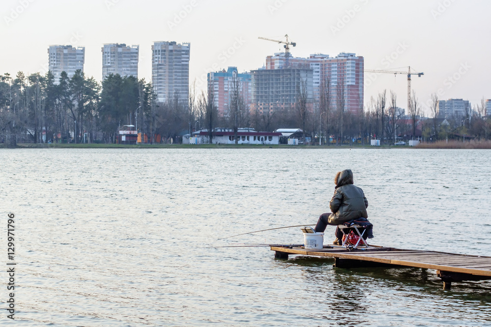 Sitting fisherman scenic autumn urban landscape