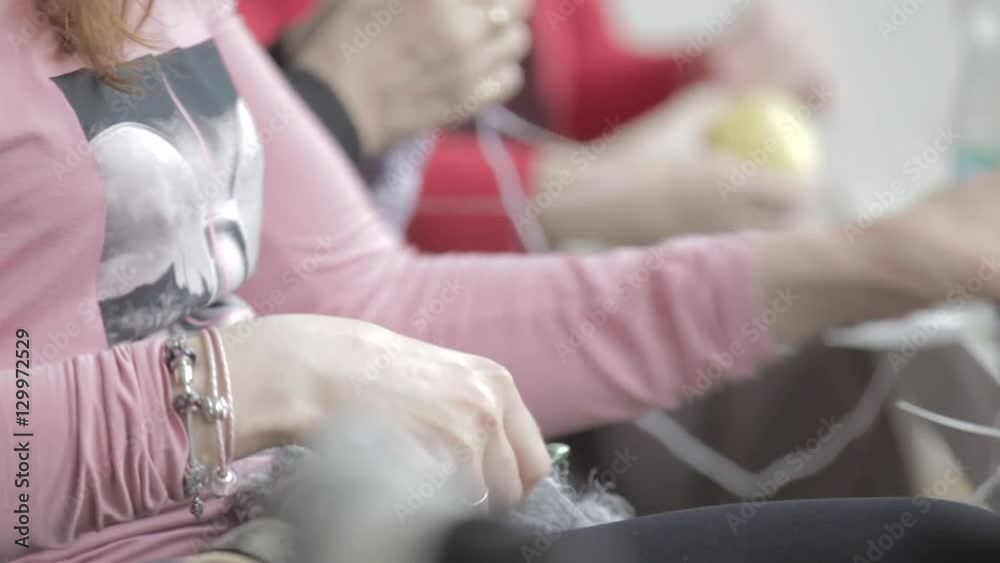 Woman knitting products made of silver thread