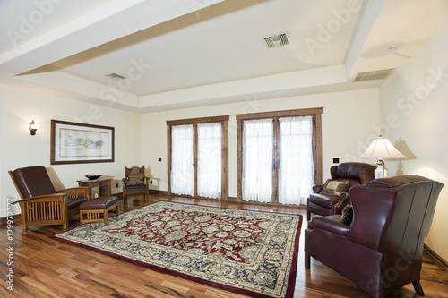 Leather furniture with rug on wooden floor at a spacious living room in home