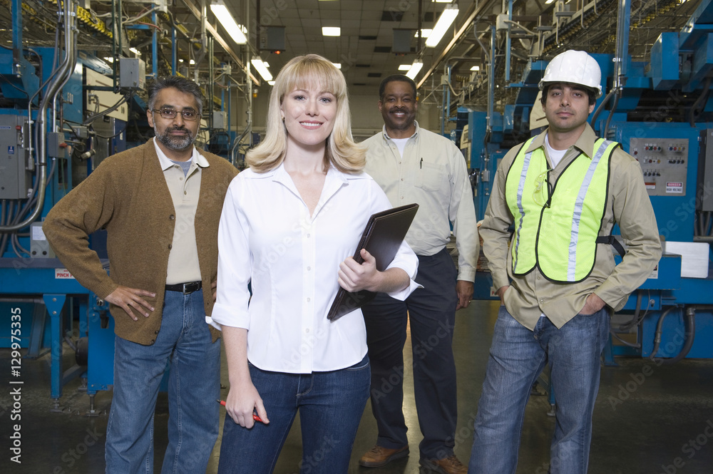 Obraz premium Group portrait of multiethnic operators standing in the factory