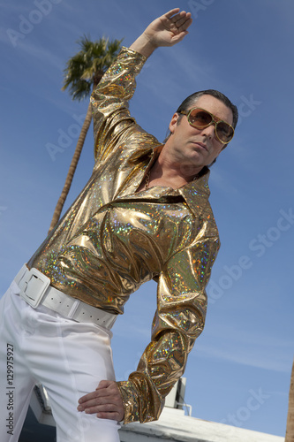 Fotografija Low angle view of middle-aged posing against sky