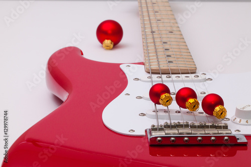 Red electric guitar and Christmas decoration photo