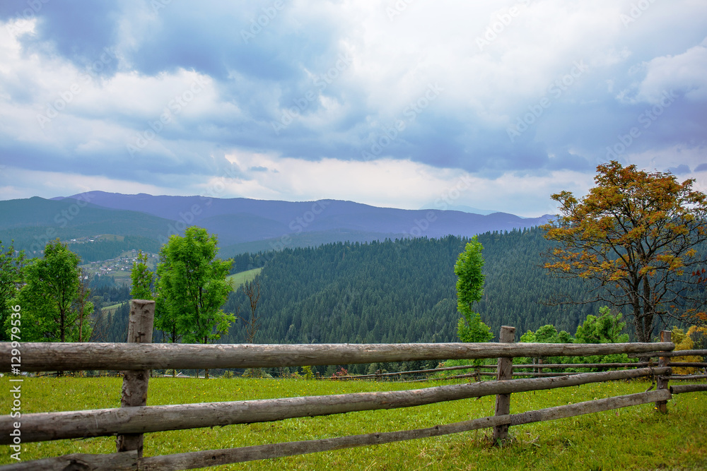 wooden fence in the mountains summer day