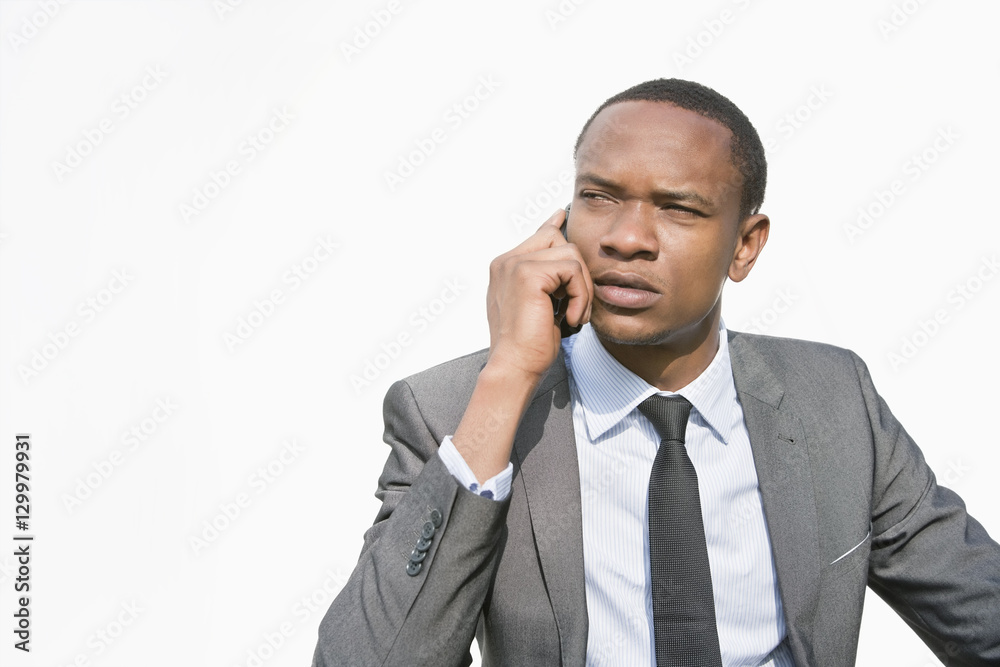 African American businessman on a call over white background African American businessman on a call over white background