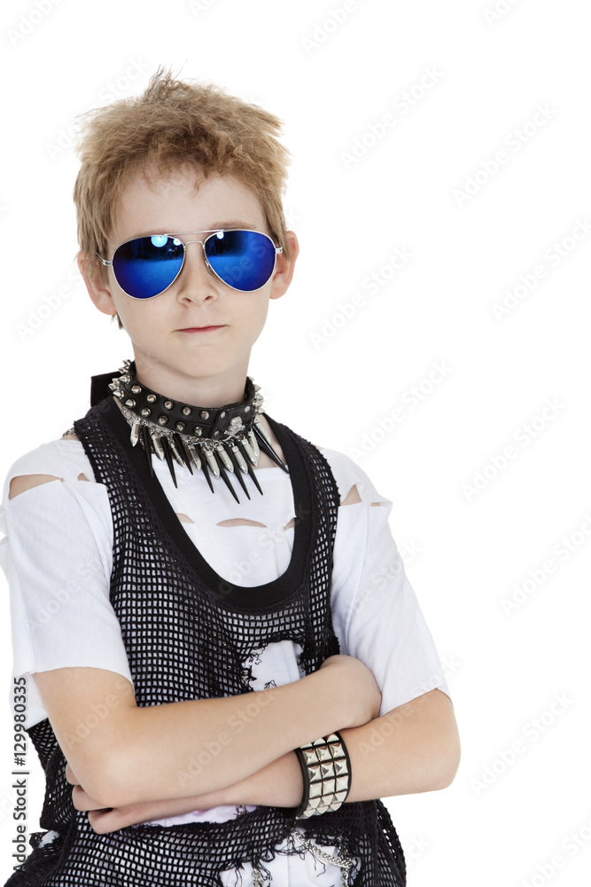 Portrait of punk pre-teen boy wearing sunglasses with arms crossed