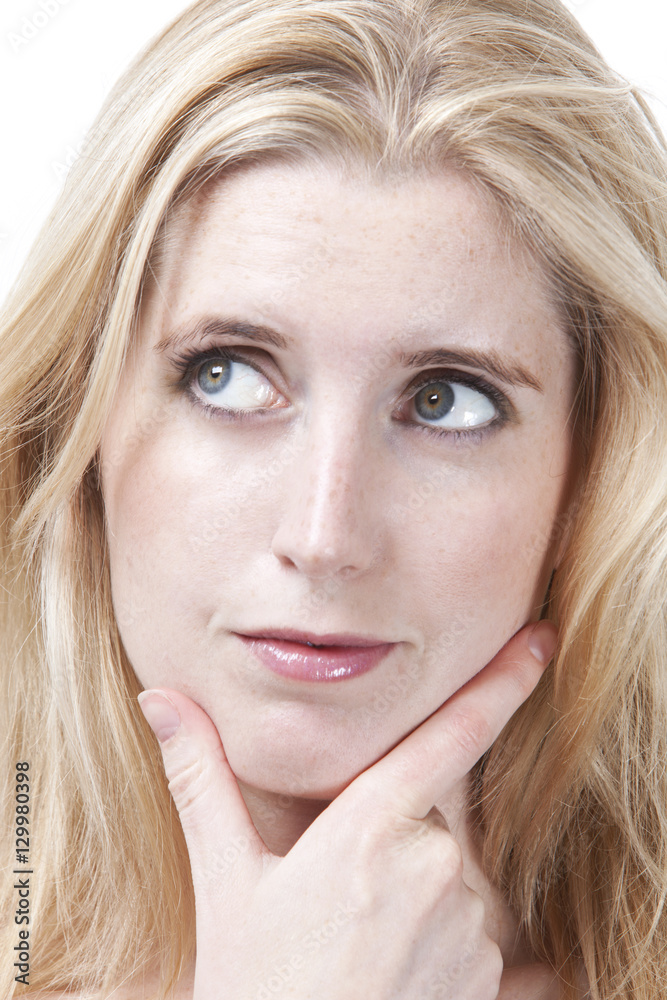 Close-up of thoughtful young woman with hand on chin looking away Close-up of thoughtful young woman with hand on chin looking away