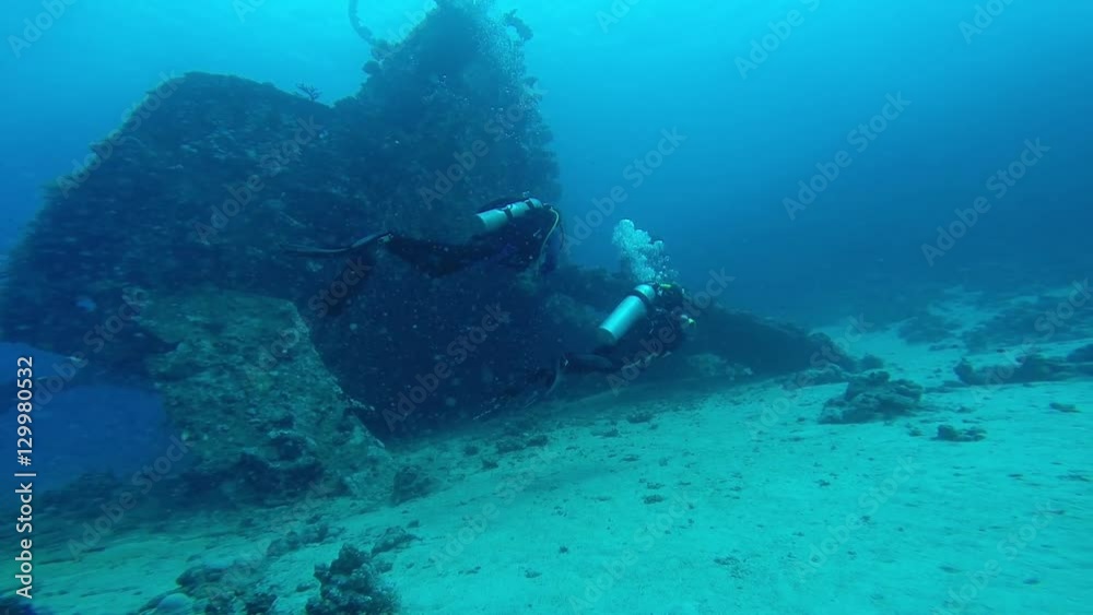 Diving in the red sea a group of divers submerged. Diving in the red sea a group of divers submerged.