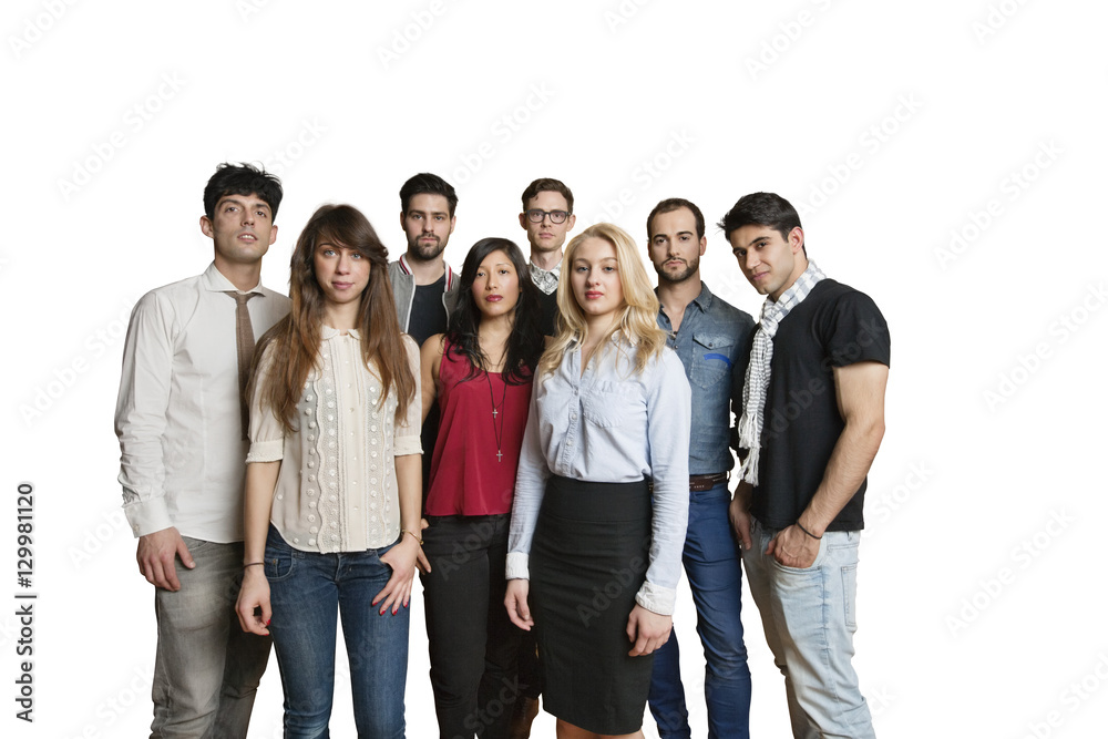 Portrait of multiethnic group of friends standing together over colored background