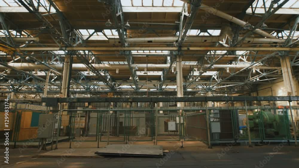 Production premise with a high ceiling and a large number of industrial equipment throughout the territory. Many metal structures, ventilation pipes used in building construction. Big light windows in Production premise with a high ceiling and a large number of industrial equipment throughout the territory. Many metal structures, ventilation pipes used in building construction. Big light windows in