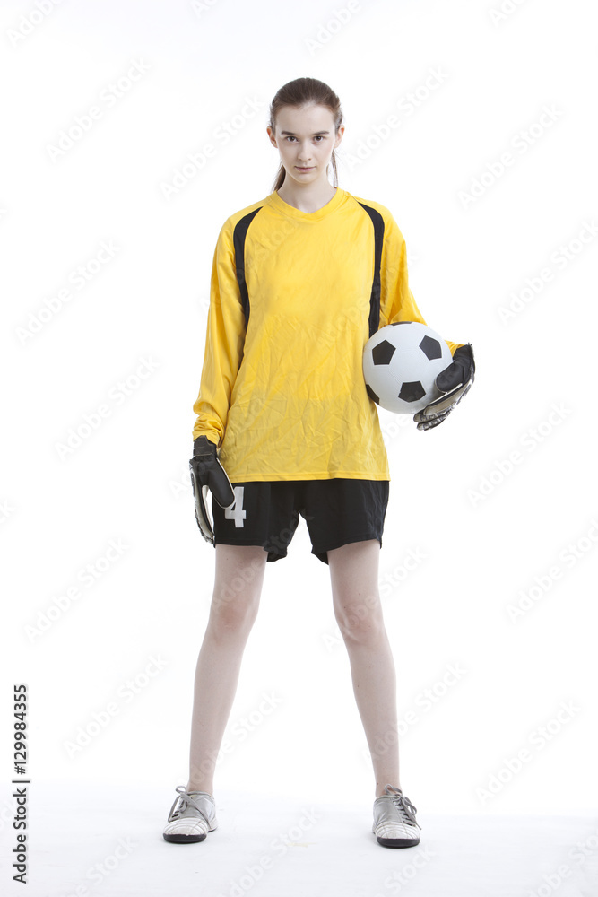 Portrait of young woman with soccer ball against white background