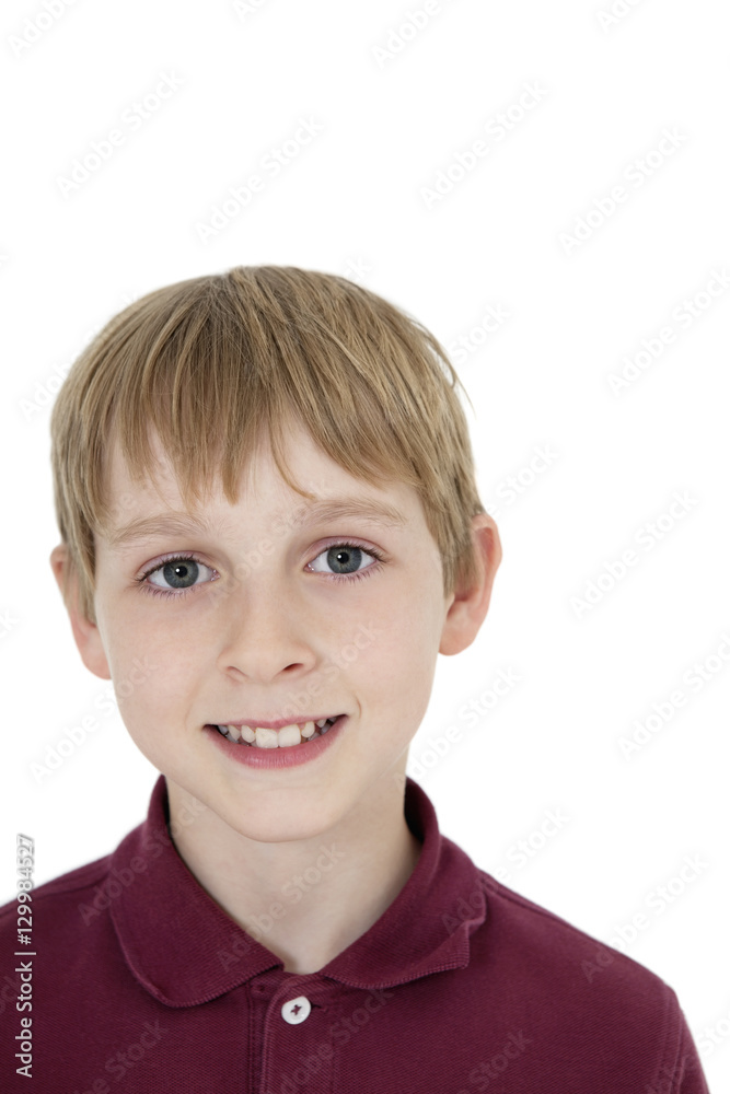 Close-up portrait of happy blond boy over white background Close-up portrait of happy blond boy over white background