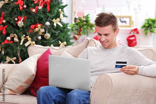 Young man shopping online w...