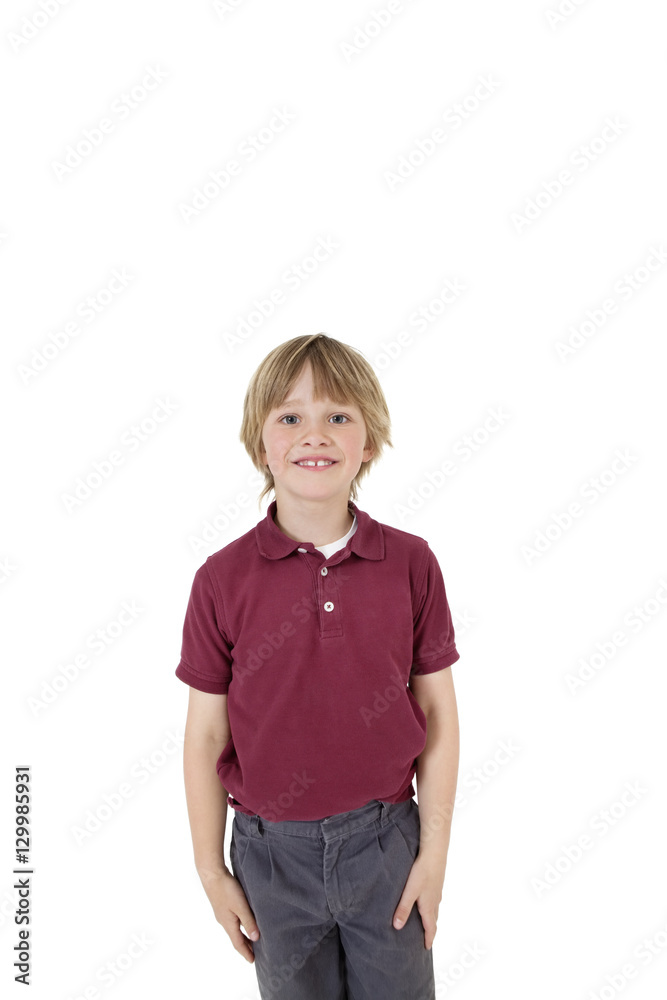 Portrait of happy elementary boy in school uniform over white background Portrait of happy elementary boy in school uniform over white background
