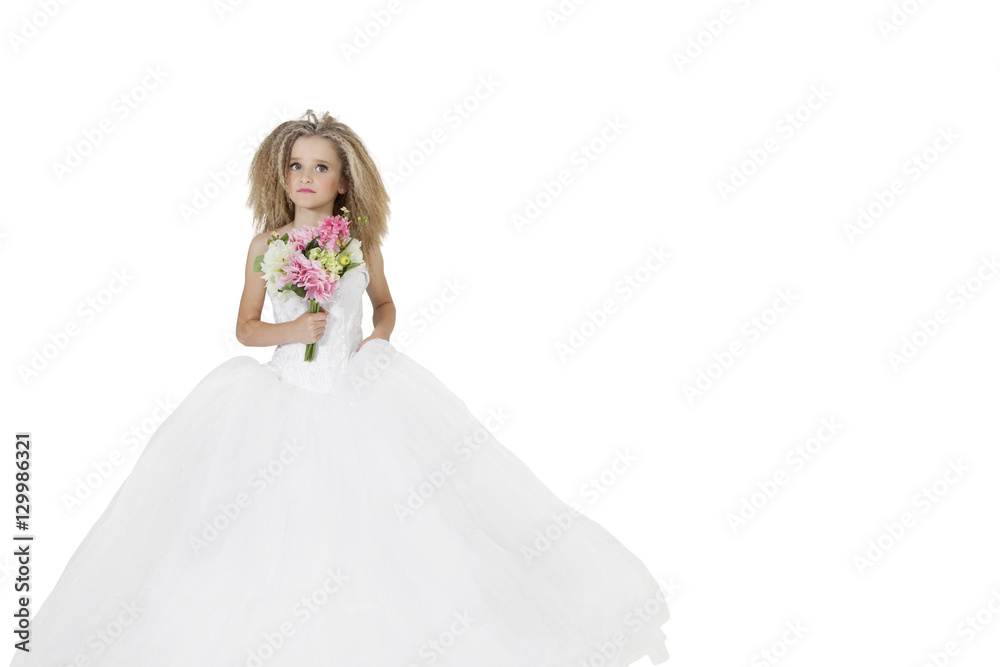 Girl in wedding dress holding flower bouquet while looking away over white background Girl in wedding dress holding flower bouquet while looking away over white background