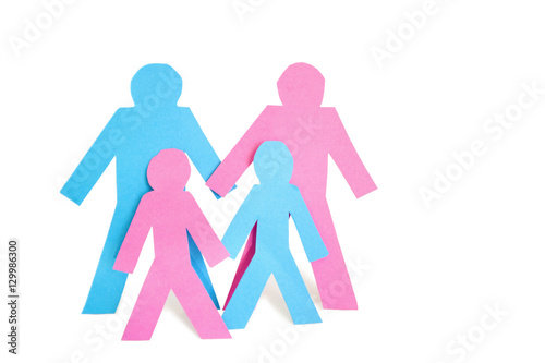 Conceptual image of paper cut outs representing family with two children over white background