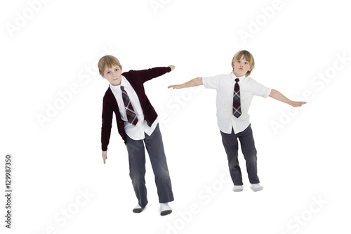 Boys with arms outstretched over white background