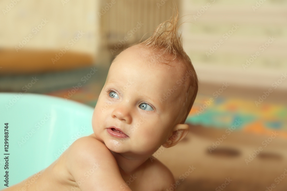 Little baby boy washing in bathtub indoors Little baby boy washing in bathtub indoors
